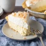 Delicious homemade Coconut Cream Pie topped with whipped cream and toasted coconut