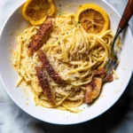 Delicious Lemon Butter Pasta with Chicken on a plate garnished with parsley