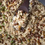 A delicious bowl of Jamaican Rice and Peas served with fresh herbs.