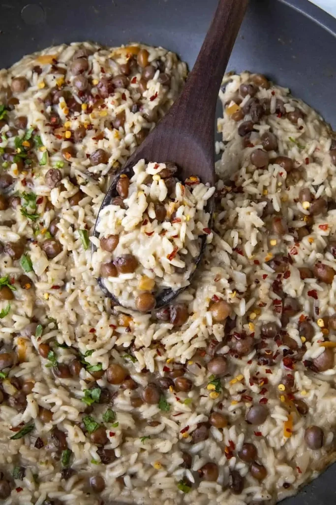 A delicious bowl of Jamaican Rice and Peas served with fresh herbs.