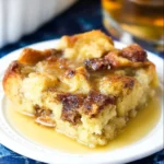 Delicious homemade bread pudding served in a bowl with a sprinkle of cinnamon.