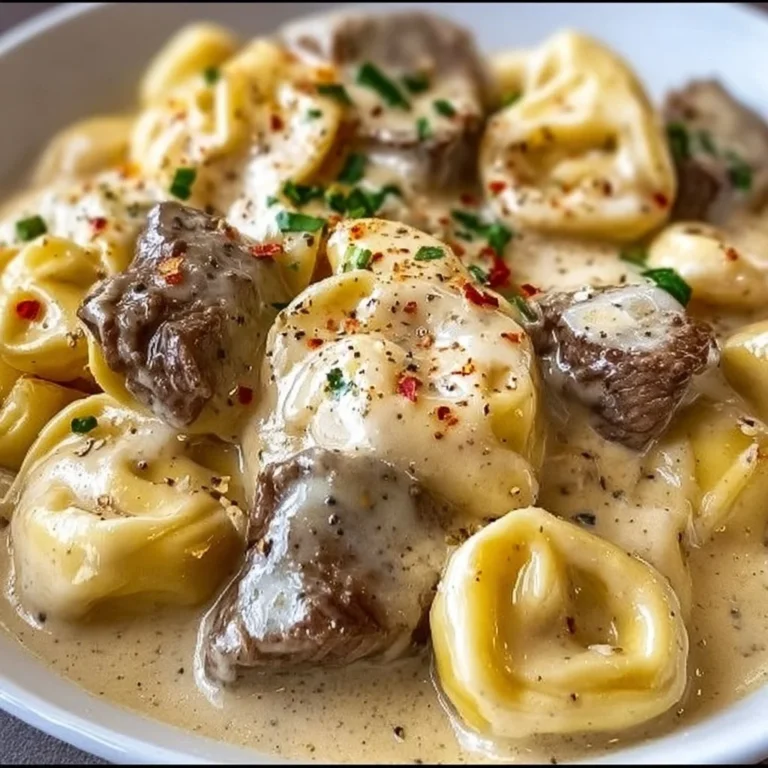 Delicious Cheesesteak Tortellini in creamy provolone sauce served in a bowl