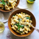 Creamy cauliflower pasta dish topped with fresh herbs and cheese
