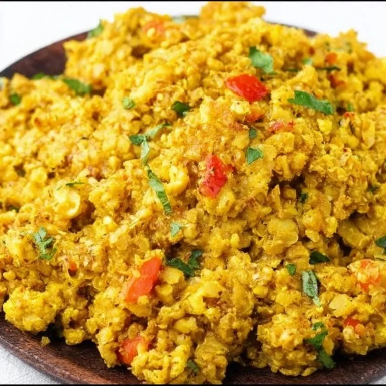 Bowl of Curry Cauliflower Rice topped with fresh herbs and spices