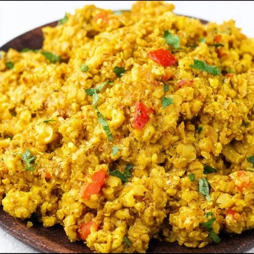 Bowl of Curry Cauliflower Rice topped with fresh herbs and spices