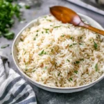 Bowl of easy rice pilaf garnished with herbs and spices