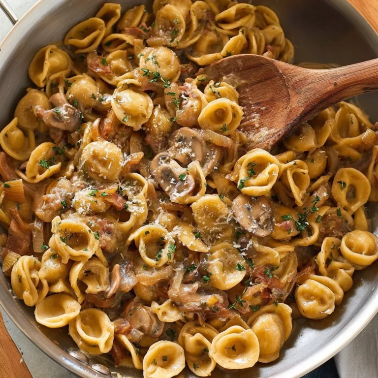 A delicious serving of French Onion Pasta topped with melted cheese and caramelized onions.