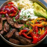 Delicious high protein steak fajita bowl with colorful vegetables and spices