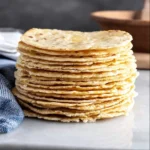 Freshly made homemade tortillas on a wooden surface