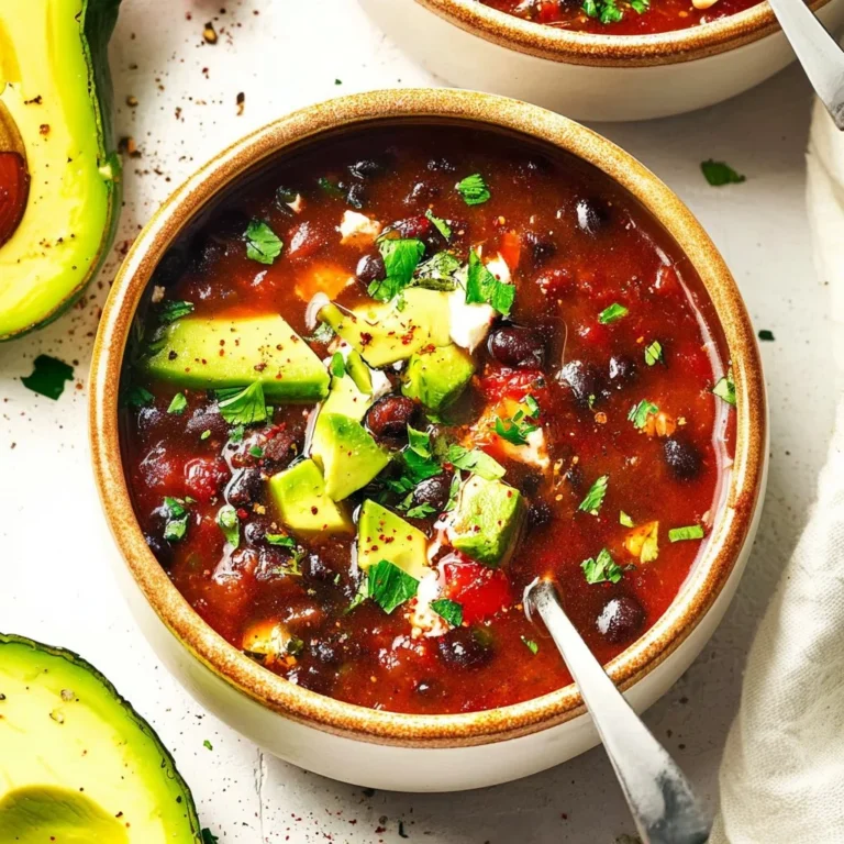A bowl of quick black bean soup garnished with fresh cilantro and lime.