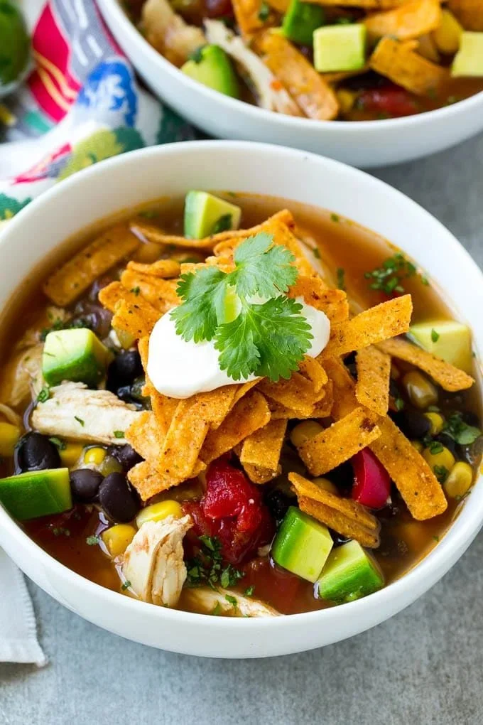 Bowl of Slow Cooker Chicken Tortilla Soup topped with avocado and cilantro
