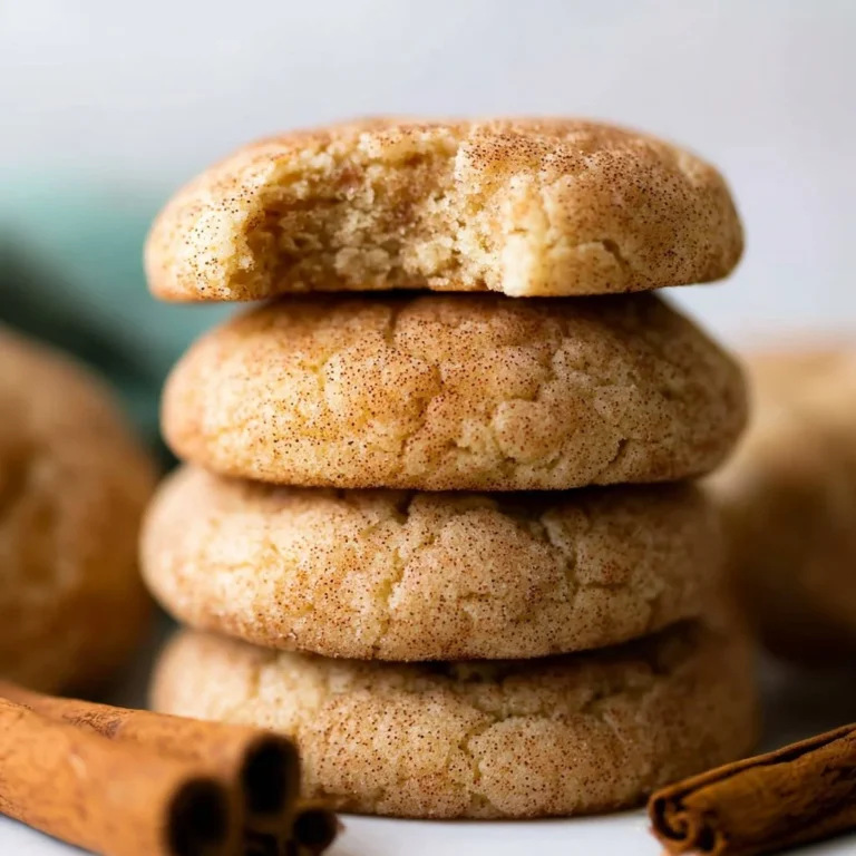 Plate of soft and thick snickerdoodles with cinnamon and sugar on top.