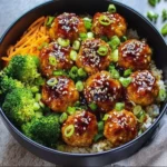 Sweet and spicy sesame chicken meatballs served in a colorful bowl with vegetables.