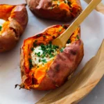 Deliciously baked sweet potato served with toppings on a plate