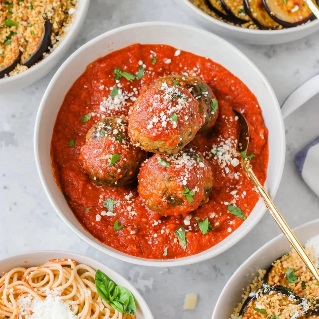 Savory eggplant meatballs served with fresh herbs and sauce