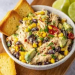 Colorful Southwest Chicken Salad topped with grilled chicken, avocado, and toppings.