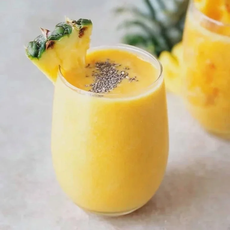 Anti-inflammatory pineapple smoothie in a glass with tropical garnishes