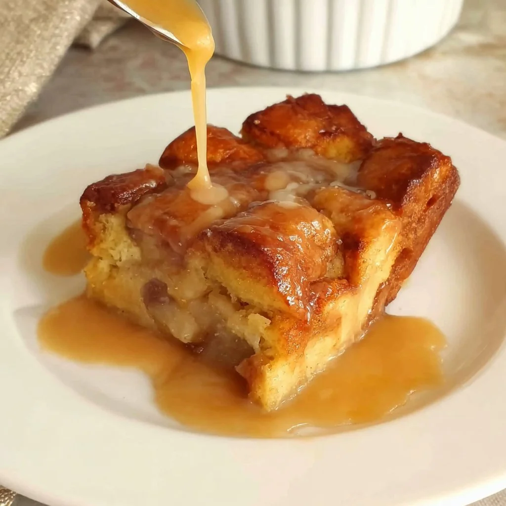 Delicious bread pudding served warm with a drizzle of caramel sauce.