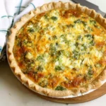 Delicious broccoli quiche served on a plate, showcasing vibrant green hues.