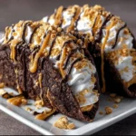 Brownie dessert tacos filled with peanut butter and topped with chocolate drizzle.