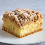 Delicious crumble cake topped with a rich layer of crumb topping, perfect for comfort food.