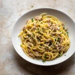 Easy canned tuna pasta dish served in a bowl with herbs and spices
