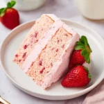 Homemade strawberry cake topped with strawberry buttercream frosting