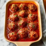 Delicious porcupine meatballs served with a savory sauce on a plate.