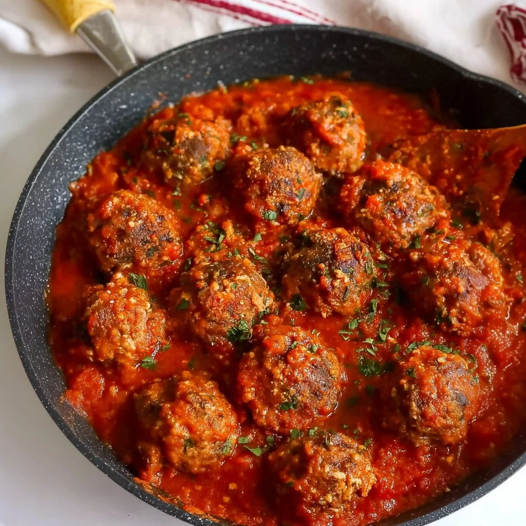 Porcupine meatballs served with sauce and herbs on a wooden table