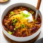 Bowl of the best chili recipe filled with beans, tomatoes, and spices.