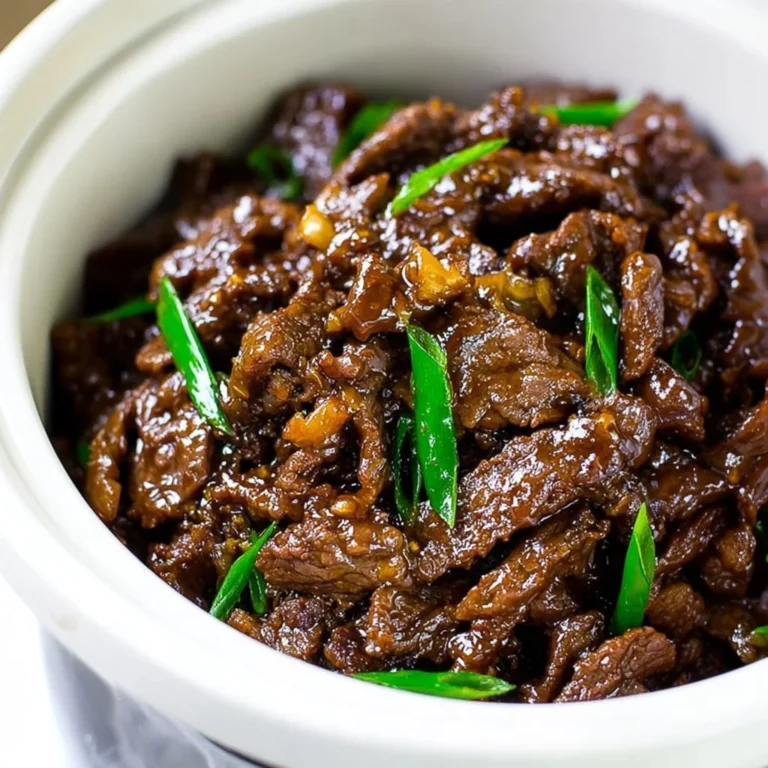 Delicious slow cooker Mongolian Beef served with rice and vegetables.