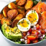 Smoked salmon breakfast bowl with fresh ingredients and vibrant colors