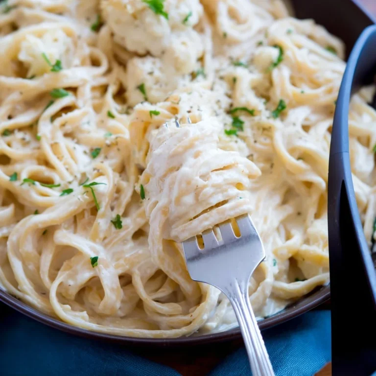 Creamy Cauliflower Alfredo Sauce served over pasta with parsley garnish