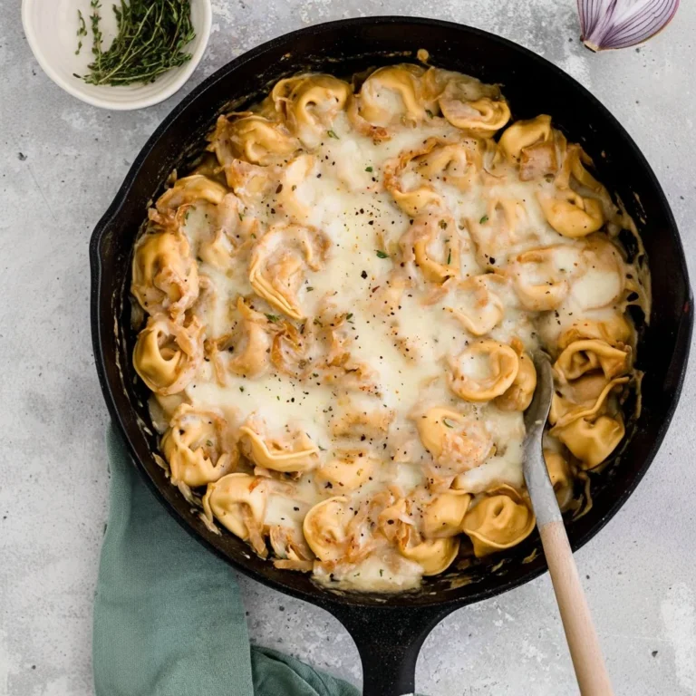 Bowl of creamy French Onion Tortellini garnished with herbs