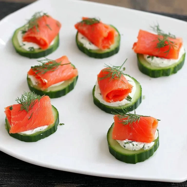 Delightful smoked salmon and cucumber appetizer served on a platter.