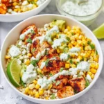 Colorful street corn chicken bowls garnished with fresh ingredients