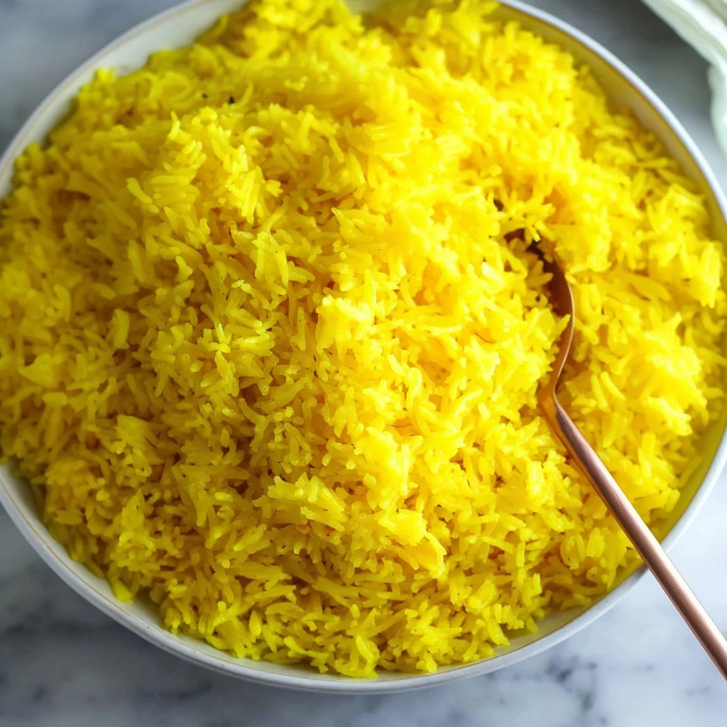 Delicious fluffy saffron rice served in a bowl, garnished and ready to enjoy.