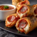 High protein pepperoni pizza rolls stacked on a plate