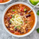 Bowl of Instant Pot Chili topped with cilantro and served with bread.
