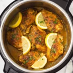 Delicious Instant Pot Lemon Garlic Chicken served on a plate with herbs.