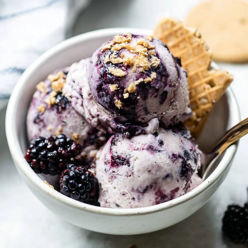 A bowl of Blackberry Cottage Cheese Ice Cream topped with fresh blackberries.