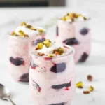 Delicious Light Cherry Coconut Yogurt Fool dessert topped with cherries and coconut flakes.