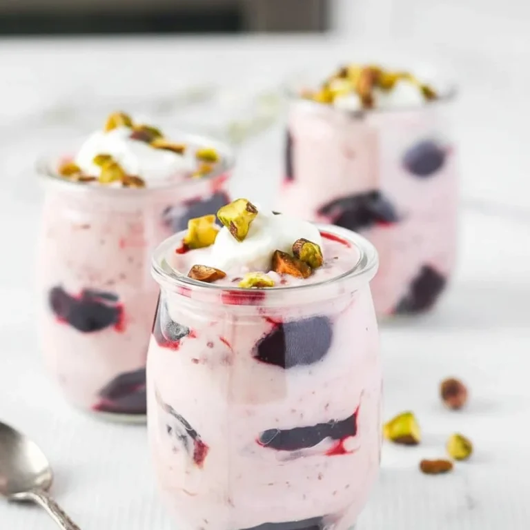 Delicious Light Cherry Coconut Yogurt Fool dessert topped with cherries and coconut flakes.