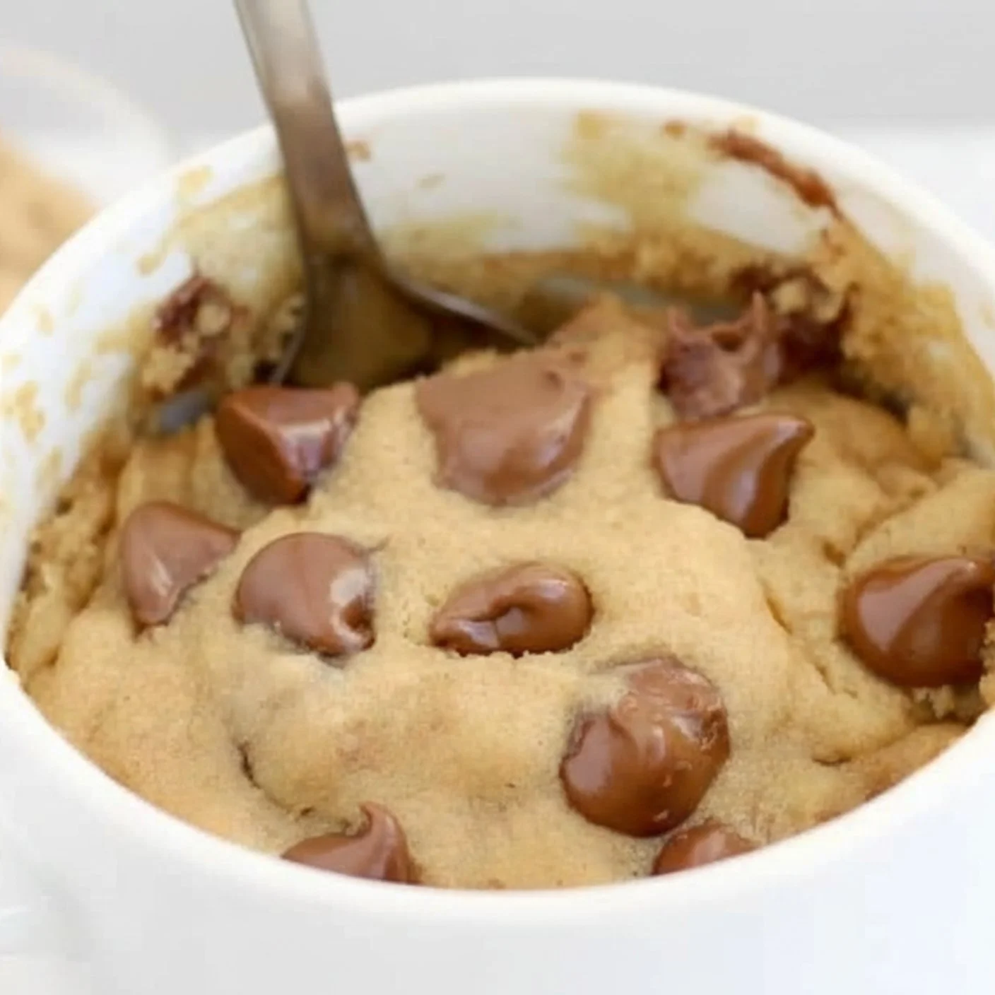 Peanut Butter Chocolate Chip Mug Cake topped with chocolate chips