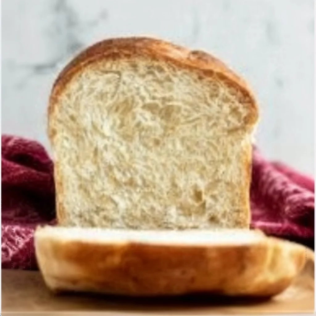 Homemade sandwich bread fresh out of the oven, ideal for all your favorite fillings.