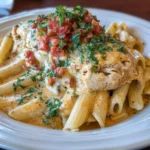 Delicious slow cooker cheesy chicken penne pasta dish with melted cheese.