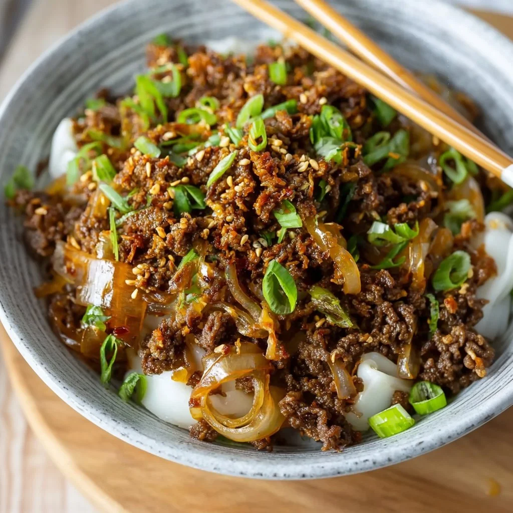 Delicious Sticky Hoisin Beef served in a bowl, perfect for comforting meals.