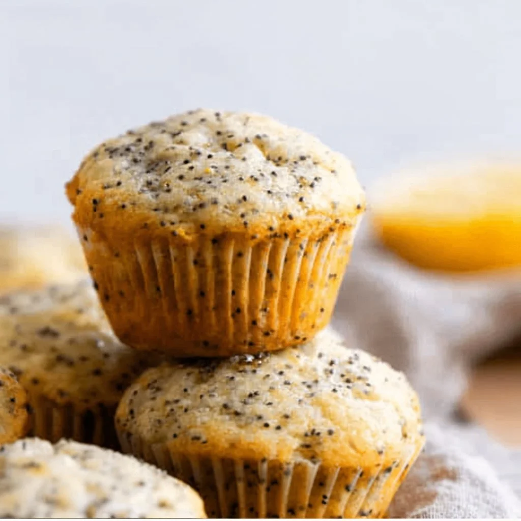 Freshly baked lemon poppyseed muffins on a wooden table