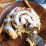 Deliciously topped yeast-free Greek yogurt cinnamon rolls on a baking sheet.