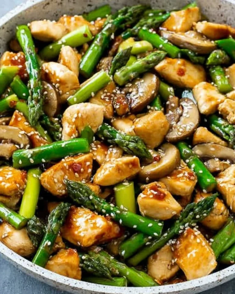 Easy chicken asparagus stir fry recipe with fresh vegetables in a skillet